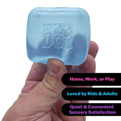 Hand holding translucent blue NEE DOH cube with glitter, labeled for home/work/play sensory satisfaction